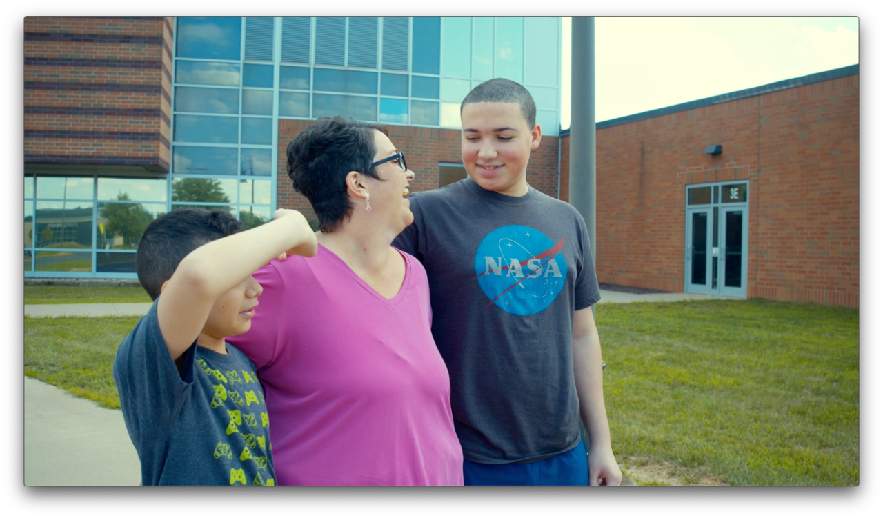 Anne with her sons in front of Jackson High School